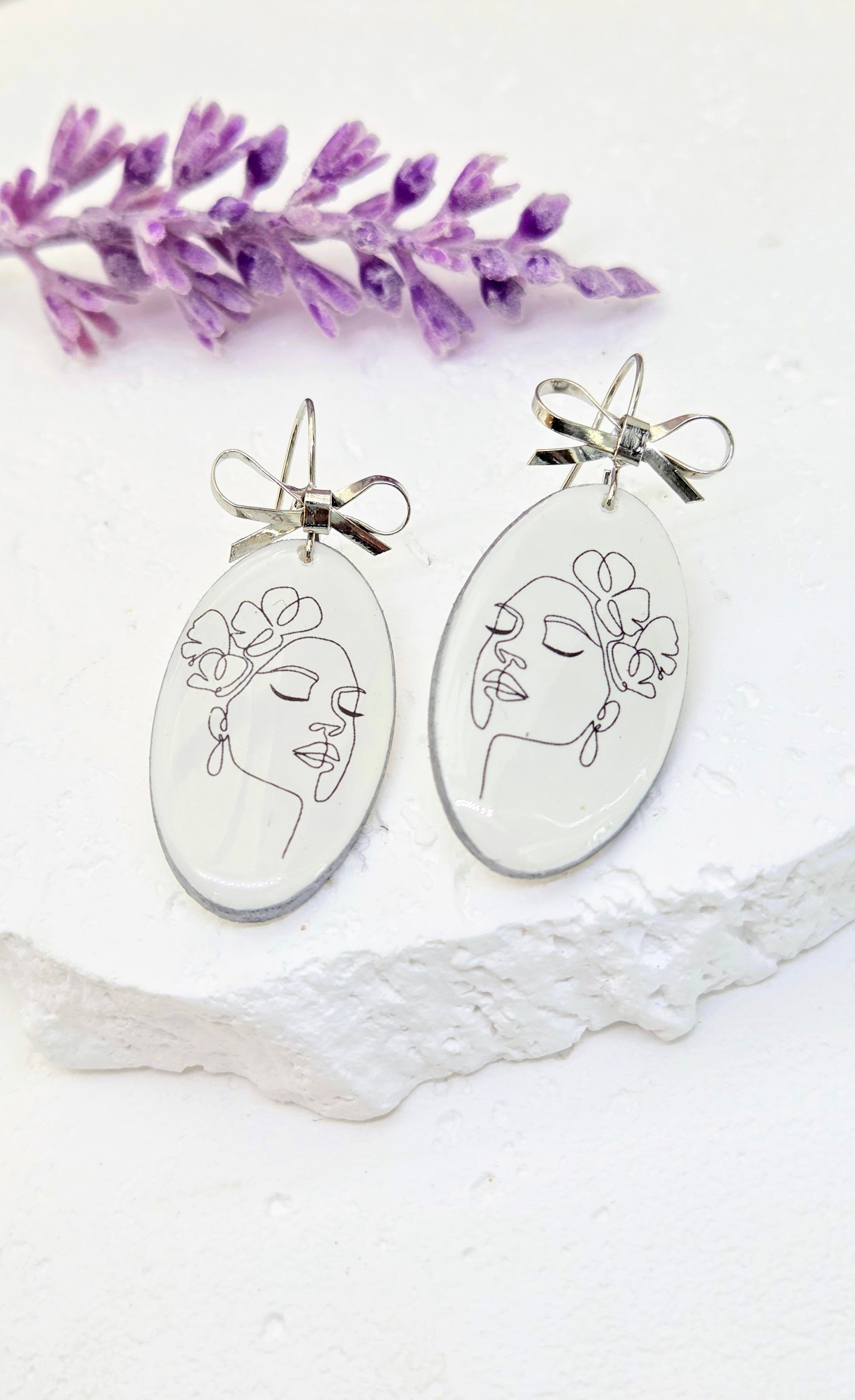 Abstract Face Clay Earrings with Bow Accent