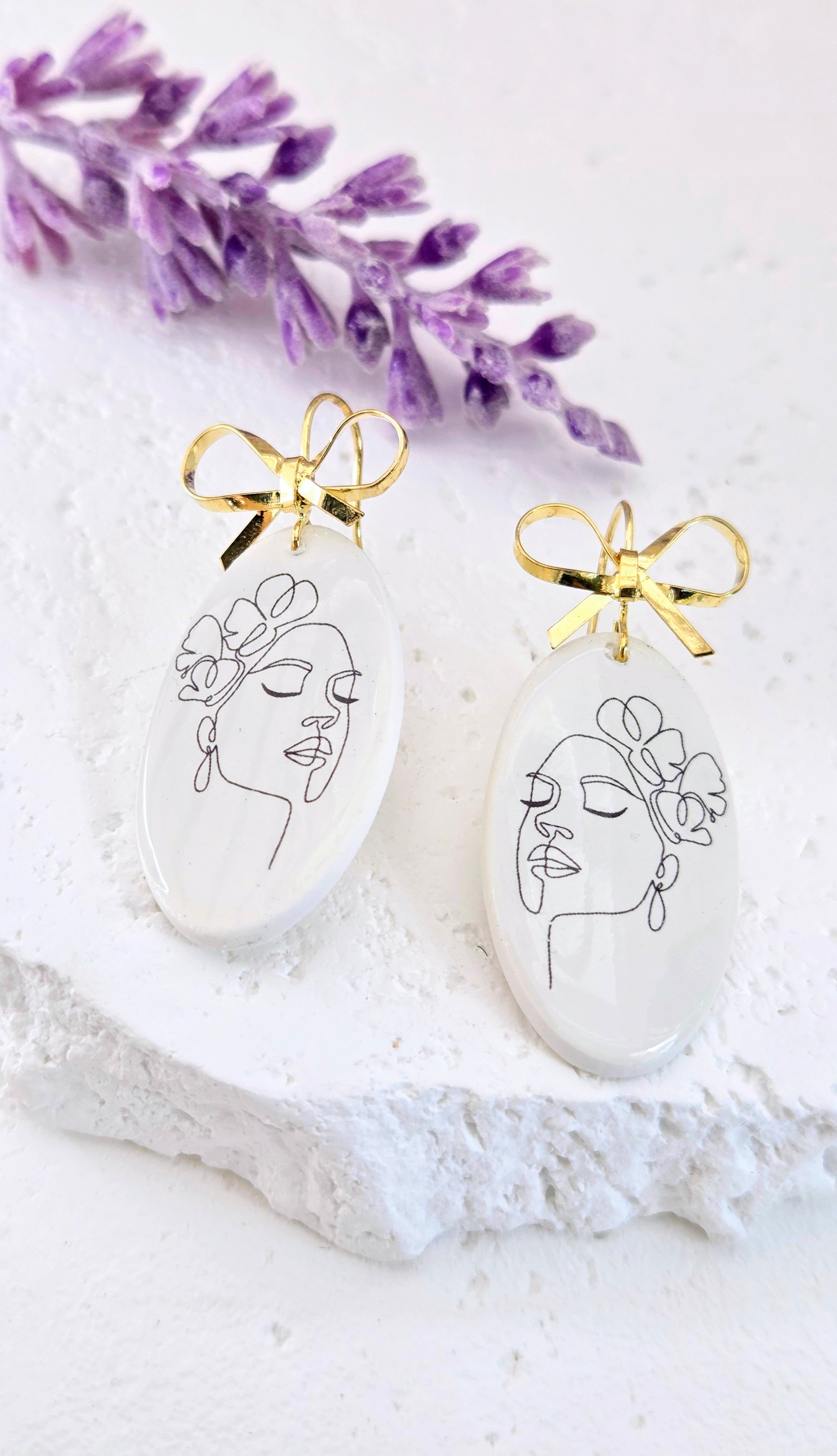 Abstract Face Clay Earrings with Bow Accent