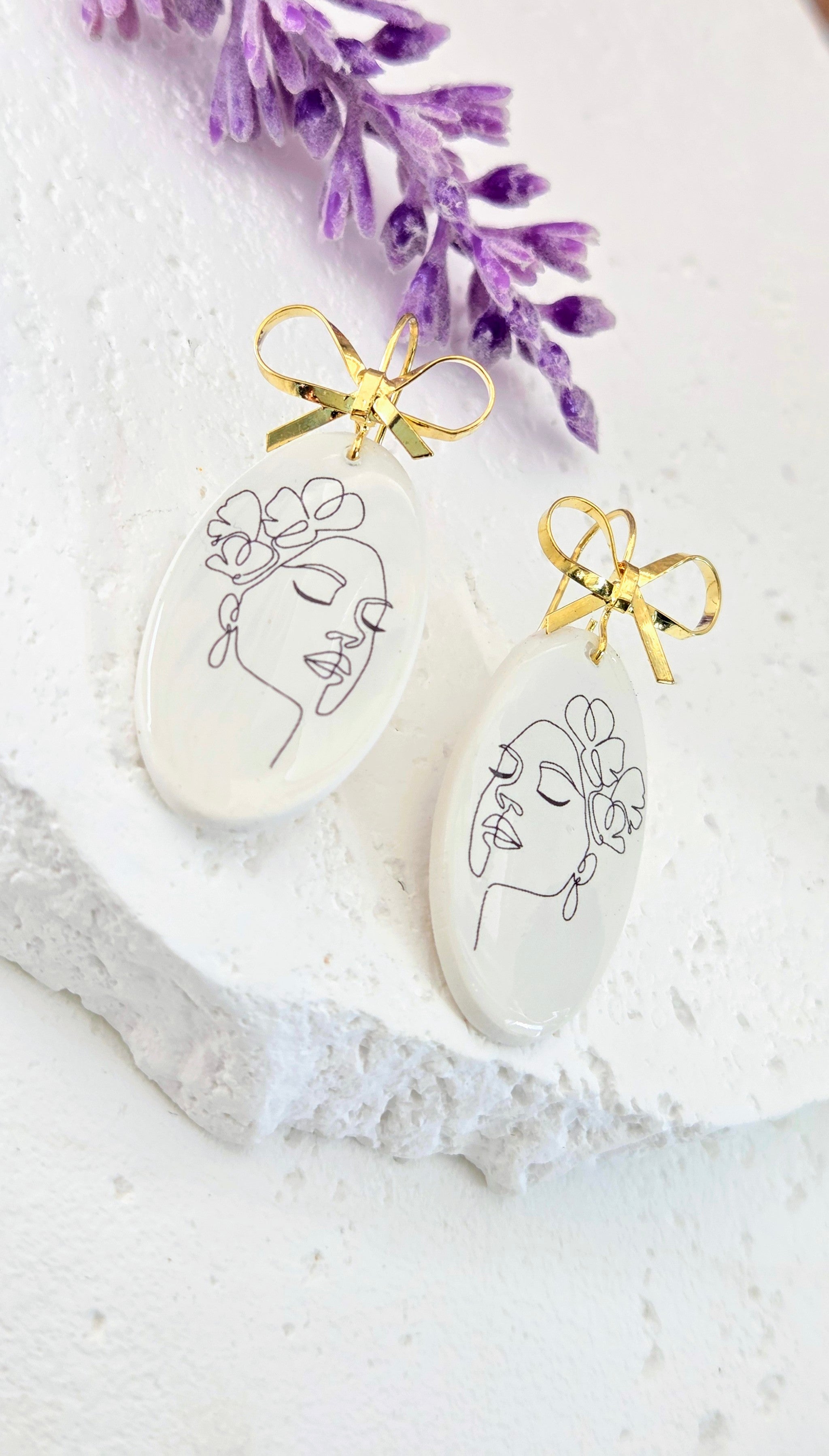 Abstract Face Clay Earrings with Bow Accent