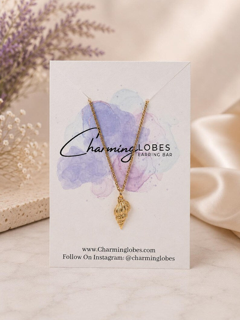 Gold conch shell necklace on a Charming Lobes card