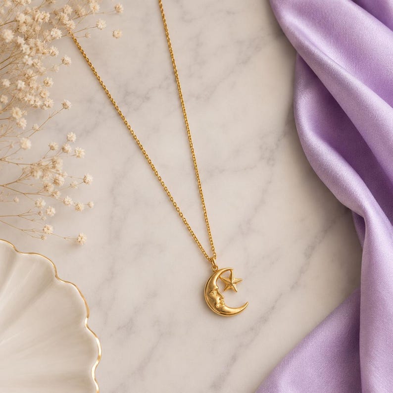 Close-up of gold crescent moon face pendant with small star