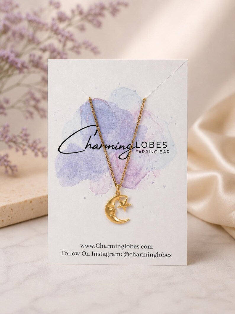 Gold moon and star necklace on a Charming Lobes card