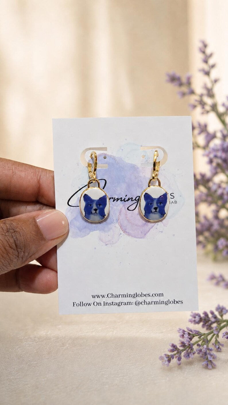 Blue dog charm earrings displayed on a Charming Lobes earring card